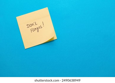 A simple yellow sticky note on blue, perfect for adding your reminder! - Powered by Shutterstock