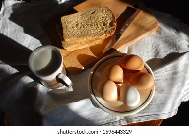 The simplest things, such as sliced bread, eggs on a saucer and a mug of real milk, can make up both an excellent meal and an attractive still life, especially in the morning sun. - Powered by Shutterstock