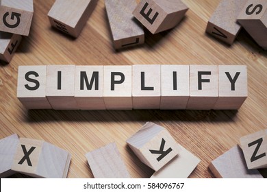 Simplify Word Written In Wooden Cube