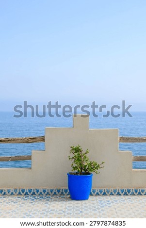 simplistic view of a moroccan style terrace with blue sea in the background, background image