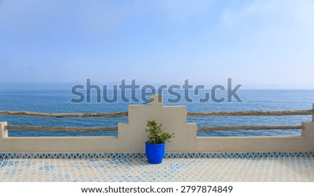 simplistic view of a moroccan style terrace with blue sea in the background, background image