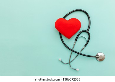 Simply Minimal Design With Medicine Equipment Stethoscope Or Phonendoscope And Red Heart Isolated On Trendy Pastel Blue Background. Instrument Device For Doctor. Health Care Life Insurance Concept