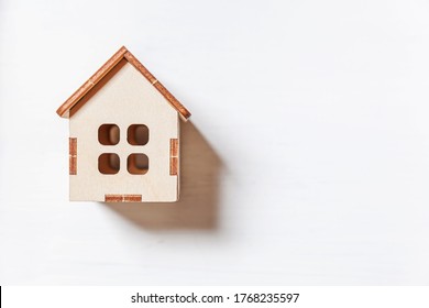 Simply minimal design with miniature toy house isolated on white background. Mortgage property insurance dream home concept. Flat lay top view copy space