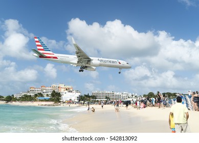 Simpson Bay, Sint Maarten-December 18, 2016: American Airline Plane Landing Over A Crowd Of People On St Maarten