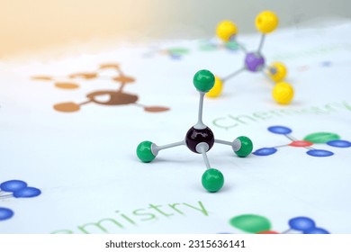 Simulate Shape of covalent molecules on english alphabet background Written in the text "Chemistry" and drawing molecular shapes. Soft and selective focus.                                    