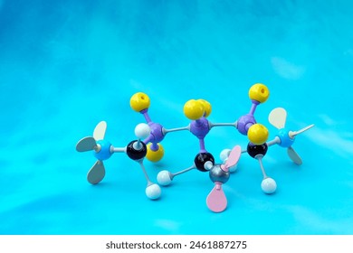 Simulate Shape of covalent molecules on a blue background. Soft and selective focus.