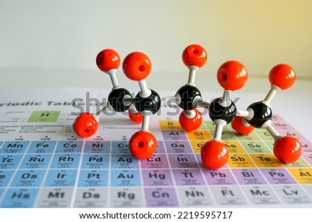 Simulate Shape of covalent molecules on a periodic table background. Soft and selective focus.                              