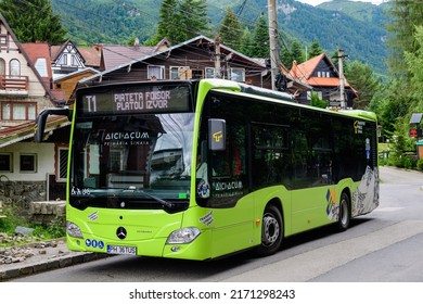 Sinaia, Romania - 3 July 2021: Green bus for the public transportation system  in a street in the center of the city close to Bucegi Mountains (Muntii Bucegi) in Prahova Valley (Valea Prahovei)