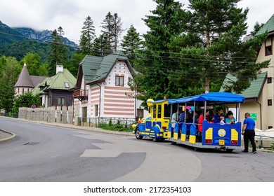 Sinaia, Romania - 3 July 2021: Colorful train for children in a street in the center of the city  close to Bucegi Mountains (Muntii Bucegi) in Prahova Valley (Valea Prahovei) in a sunny summer day