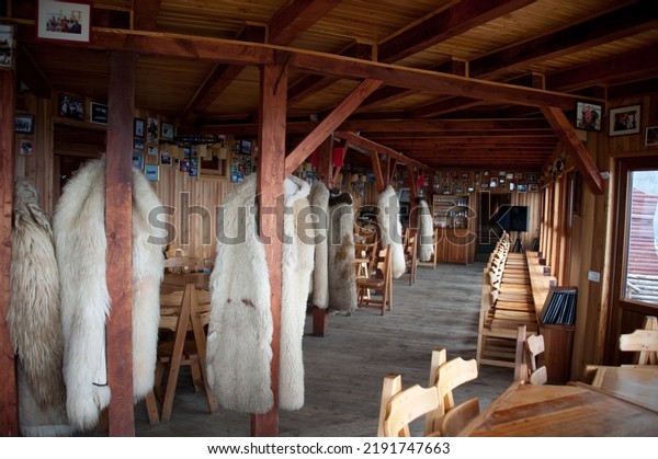 SINAIA, ROMANIA -\
JUN 5, 2014: Furs hang on the posts in the dining room of the ski\
loidge, at Cota 2000 ski\
area.