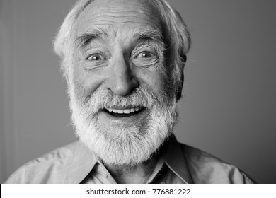 Sincere Amazement. Close Up Black-and-white Portrait Of Aged Happy Pensioner With Widely Open Eyes While Standing. Isolated On Grey Background