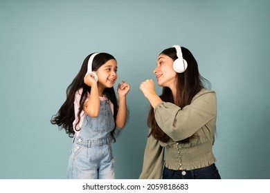 Sing With Me. Hispanic Young Mom And Little Girl Singing Together While Listening To Music With Headphones 