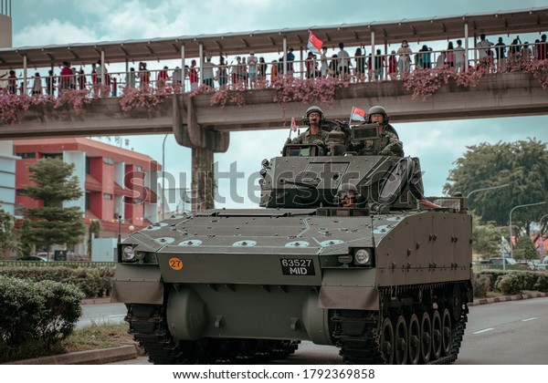 Singapore, Singapore - 08/09/2020: Singapore\
National Day Mobile Column moving through the heartlands in Kovan -\
Tank rolling through the roads in\
Singapore