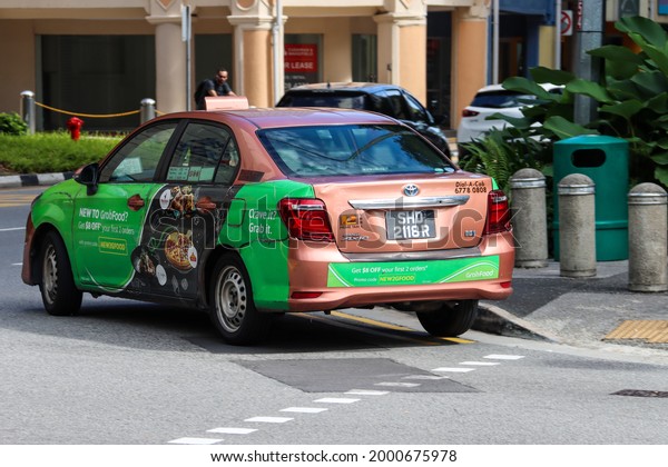 SINGAPORE - 1 JUL 2021: Wrap Adverts - A Prime taxi \
advertises Grab app via the message \