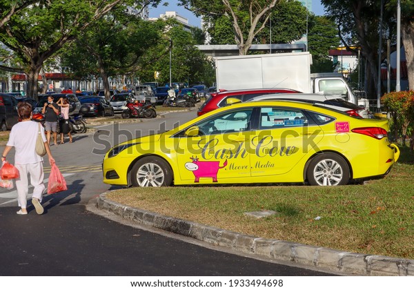 SINGAPORE - 11 MAR 2021: A Citycab taxi nowadays\
advertises more. The Cash Cow display generates revenue for the\
owner. Every source of revenue is important in the  Covid-19\
pandemic times. 