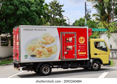 SINGAPORE - 12 DEC 2021: Vehicle wrapping advertisements on a truck delivering CP FOOD are effective outdoor mobile billboard adverts. They are much cheaper than painting artwork onto the truck.  