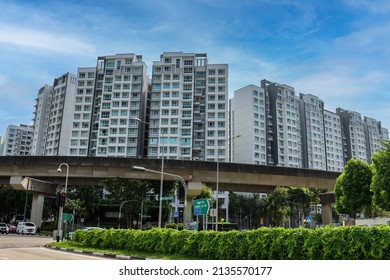 SINGAPORE - 13 MAR 2022: The fully driverless Sengkang and Punggol Light Rapid Transit (LRT)  track (foreground) serves Sengkang and Punggol - the 2 fastest-growing residential estates in Singapore. 