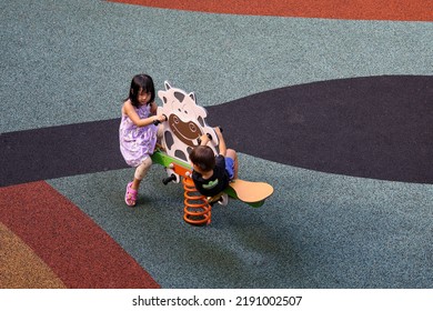 SINGAPORE - 16 AUG 2022: A Newer Children's Playground Has Rubberised Mat Instead Of Sand As Flooring. The Soft Mat Provides Safety In Case The Kids Fall Down.