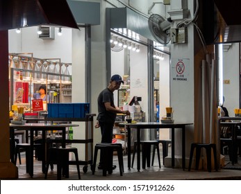 SINGAPORE - 16 MAR 2019 - A Elderly Asian Chinese Singaporean Male Employee At A Late-night Eatery / Coffeeshop / Kopitiam Enjoys A Cup Of Coffee After Work.