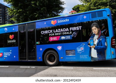 SINGAPORE - 2 JUL 2021: A Public Bus Has An Attractive Lazada Vehicle Wrap Advertisement Which Earns Income For The Owner. Bus Adverts Are Popular As They Are Effective Mobile Billboard Ads In A City.