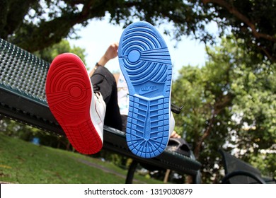 SINGAPORE, SINGAPORE - 20 January 2019: Hypebeast Fashionable Man Wearing  Pair Of Cool White Nike Lance Mountain Limited Edition Sneaker With Red And Blue Soles.