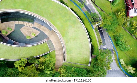 "Singapore - 2017 04 08: Aerial top view on School of Art at Nanyang technological university in Singapore. Modern architecture, unique design, green grass rooftop, interesting shape. "