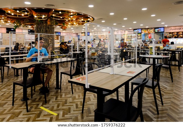 Singapore 2020Jun19 Covid-19 Phase 2 re-opening\
day. Protective shields separators have been installed at dining\
tables at Koufu food court for safe dining; social distancing,\
post-circuit breaker