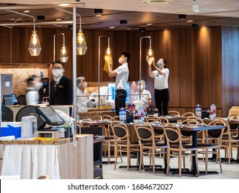 SINGAPORE – 23 MAR 2020 –  Staff At Ding Tai Fung Chinese Restaurant  Clean / Disinfect / Sanitize The Premises While Wearing Masks As A Covid-19 / Coronavirus Prevention Measure. 