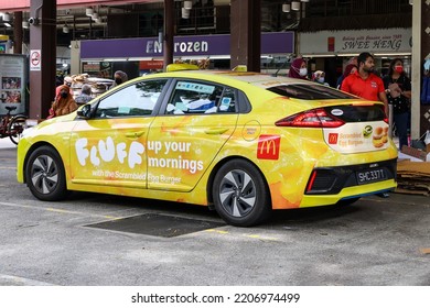 SINGAPORE - 27 SEP 2022: Vehicle Wrap Advertisement Of McDonald's Scrambled Egg Burger Creates Awareness As It Is A Mobile Advert. It Is Cheaper Than Painting Artwork Directly Onto The Taxi.