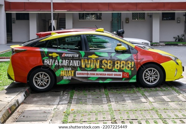 SINGAPORE - 27 SEP 2022: The vehicle wrap\
advertisement for carbuyer.com.sg\'s lucky draws create awareness\
and is cheaper than painting artwork onto the\
taxi.