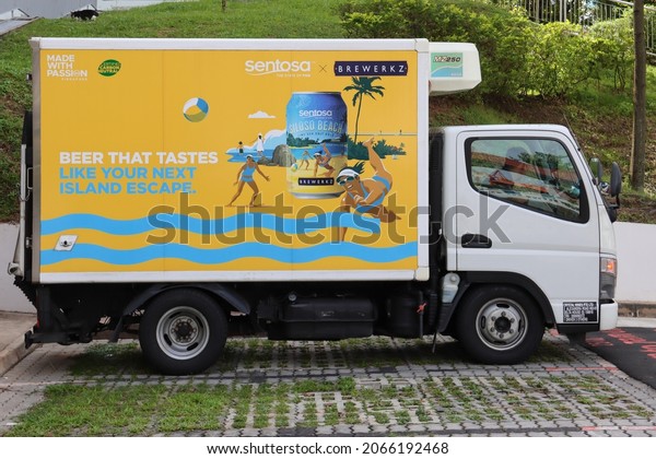 SINGAPORE - 29 OCT 2021: A vehicle\
wrapping advertisement of BREWERKZ generates revenue for the beer\
company. The truck is a mobile advert\
billboard.
