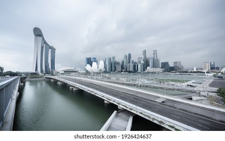 Singapore - 30 Aug 2019: Marina Bay view at sunrise with the Sands resort, the ArtScience Museum and the Helix bridge reflecting on the water, in Singapore