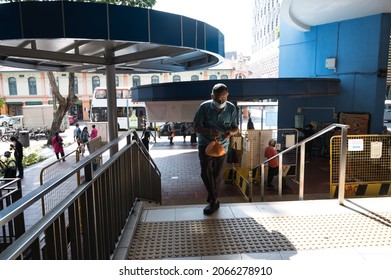 Singapore - 30th October 2021: An Elderly Man Is Reading A Newspaper At The Void Deck.