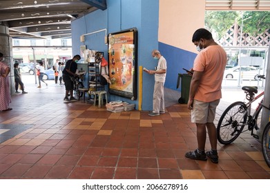 Singapore - 30th October 2021: An Elderly Man Is Reading A Newspaper At The Void Deck.