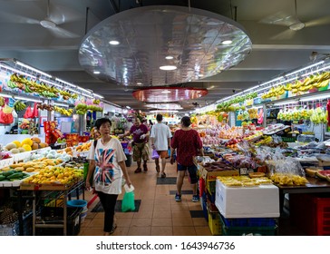 SINGAPORE – 4 JAN 2020 – A Customer Walks Past A Fruit Stall At The Ang Mo Kio Wet Market In Singapore, Southeast Asia. Tropical Fruits And Groceries Are On Display 