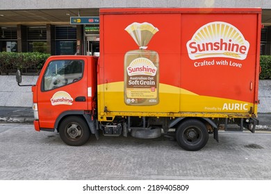 SINGAPORE - 5 AUG 2022: Vehicle wrapping advertisements on a SUNSHINE bread delivery truck are effective outdoor mobile billboard adverts. They are much cheaper than painting artwork onto the truck. 