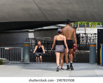 SINGAPORE - 5 JUN 2021: Two Adults Walk Briskly At The Esplanade. Regular Brisk Walking Can Promote One's Physical And Mental Health If One Has Lots Of Work To Do And Feel Depressed Or Burnt Out.