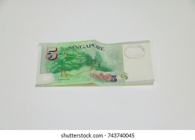 A Singapore 5-dollar Note, Reverse Side Up.