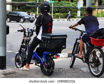 SINGAPORE - 6 JUN 2021. The  Bicycle With The Step Through Frame, Left Of Image, Is Suitable For Food Or Parcel Delivery Riders Who Require Frequent Dismounting Or Riders With Restricted Agility.