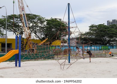 SINGAPORE -8 MAY 2021: Ang Mo Kio Town Garden West Playground's newer slides, carousels, swingset, spring riders, jungle gym and sand for children to exercise and promote socio-emotional development  