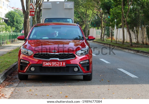 SINGAPORE - 9 JUN 2021: A car with a red car\
licence plate is an \