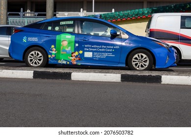 SINGAPORE - 9 NOV 2021: Vehicle wrapping advertisements on a taxi for STANDARD CHARTERED bank are effective outdoor mobile billboard adverts which are cheaper than painting artwork onto the car. 