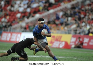 SINGAPORE - APRIL 17,2016 :Samoa 7s Rugby Team (blue) Plays Against New Zealand All Blacks 7s Rugby Team At HSBC World Rugby Sevens Series Singapore.