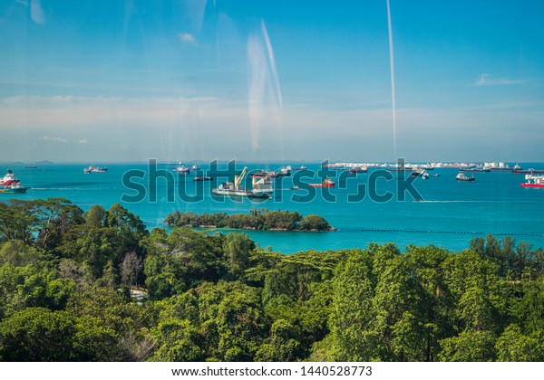 Singapore, April, 2019. View of the harbor seen\
from the Singapore Cable Car. Singapore Cable Car opened on 15\
February 1974, it was the first aerial ropeway system in the world\
to span a harbour.