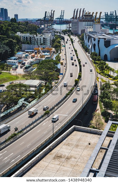 Singapore, April, 2019. View of the highway seen\
from Singapore Cable Car. Singapore Cable Car opened on 15 February\
1974, it was the first aerial ropeway system in the world to span a\
harbour.
