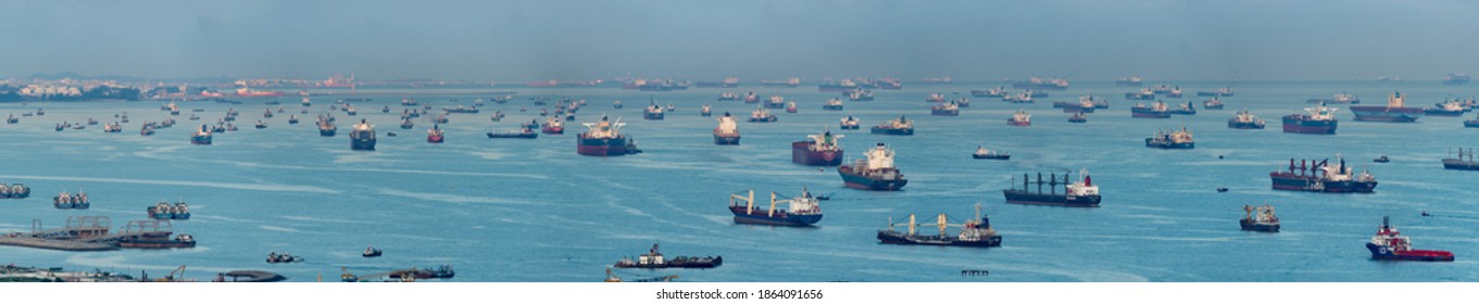 Singapore - April 2020: Wide panorama image of Container Ships and tankers anchored at the Singapore strait.