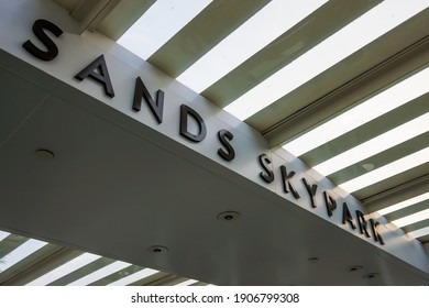 Singapore - Aug 2014: Close Up Of Sands Skypark Text Sign Above The Escalator To Admittance Or Reception Desk At Marina Bay Sands Hotel. No People.