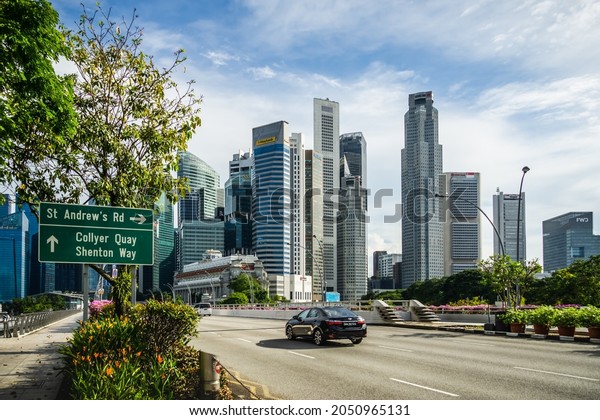 Singapore - Aug 31, 2021: Road leading to Collyer\
Quay and Shenton way with beautiful Central Business District sky\
scrapers as back\
drop.
