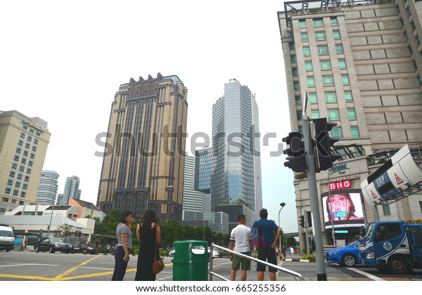 Singapore City - Apr 29: Bugis Junction in\
Singapore City on Apr 29, 2017. People standing in front of a\
traffic light at the Bugis\
Junction.