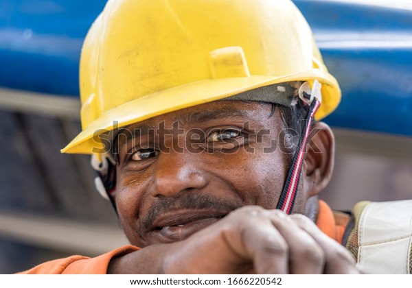 Singapore city, Singapore - february 28, 2020\
: A migrant worker poses for a photo on a city centre construction\
site in Singapore. The SE Asian city state has a significant\
migrant worker\
population